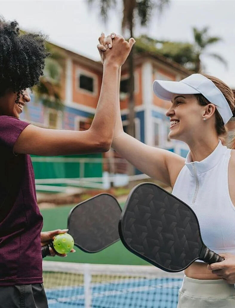 Group of founders in Saigon holding pickleball rackets, ready to play during the club’s Monday evening session