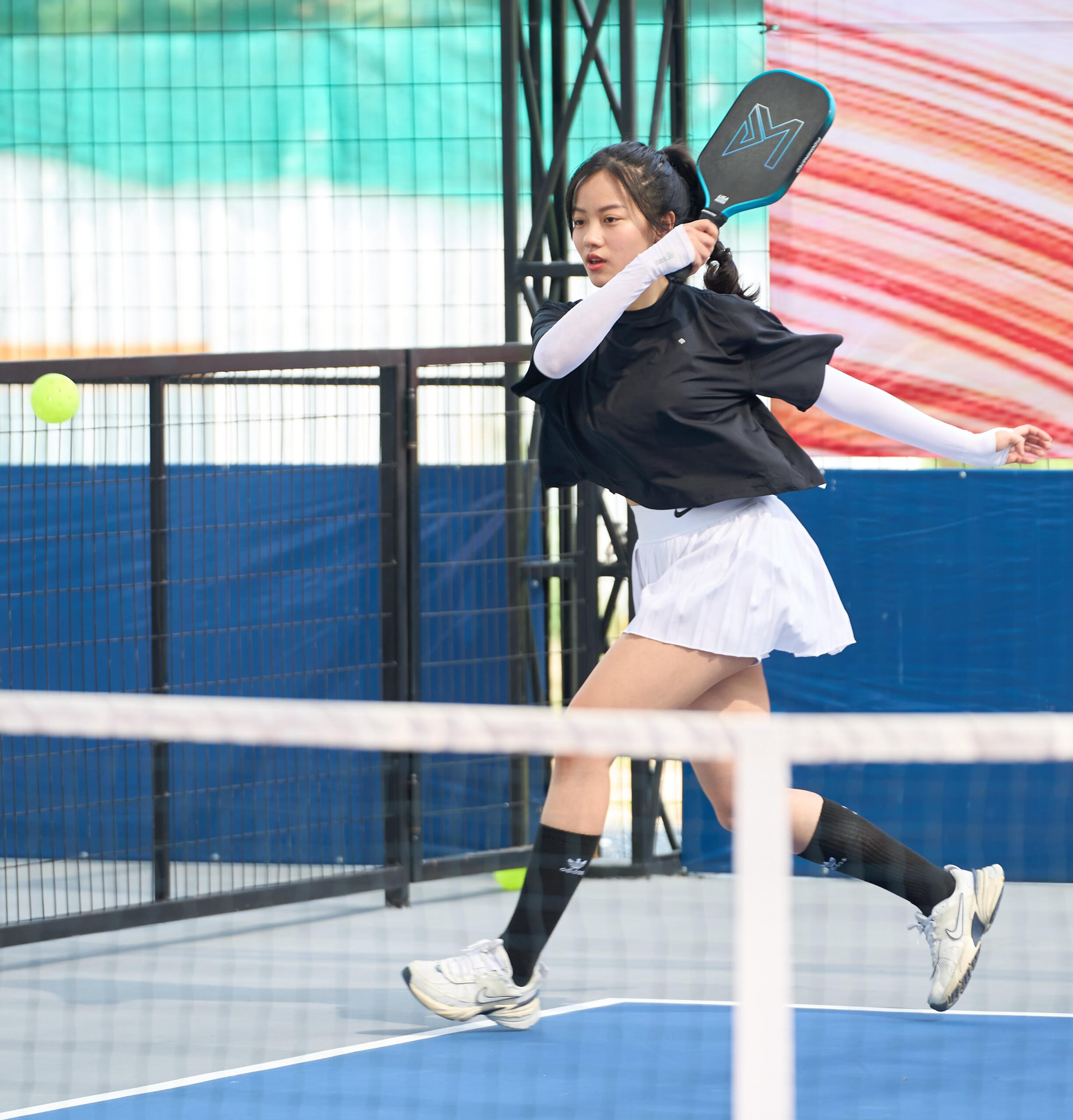 Woman entrepreneur hitting a pickleball during a Founders Pickleball Club game in Saigon
