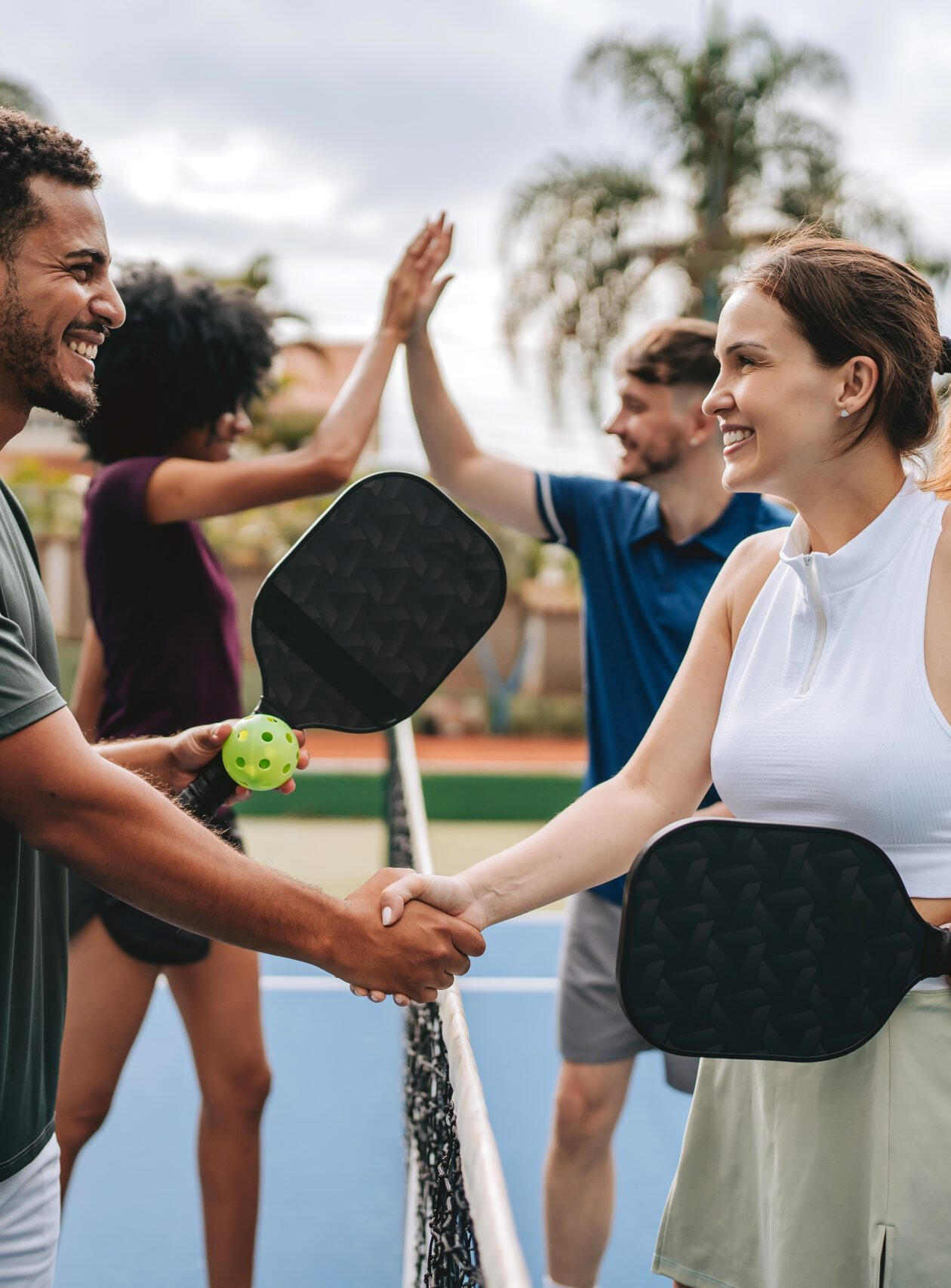 Founders Pickleball Club Saigon – Entrepreneurs playing pickleball and networking Group of entrepreneurs in Saigon playing pickleball together, meeting new people, and networking in a casual setting